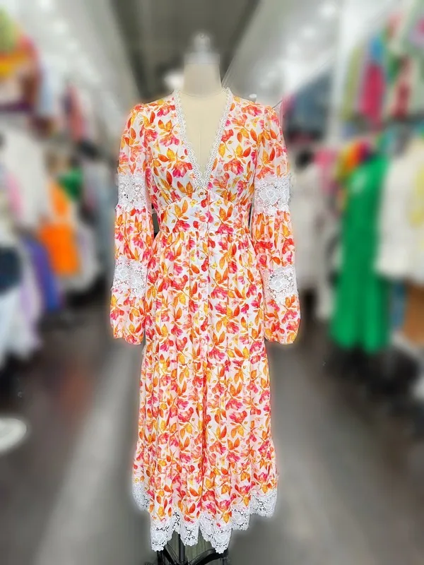 A Long Dress For Women Featuring Vibrant Floral Prints, Cutouts, And Lace Trim.