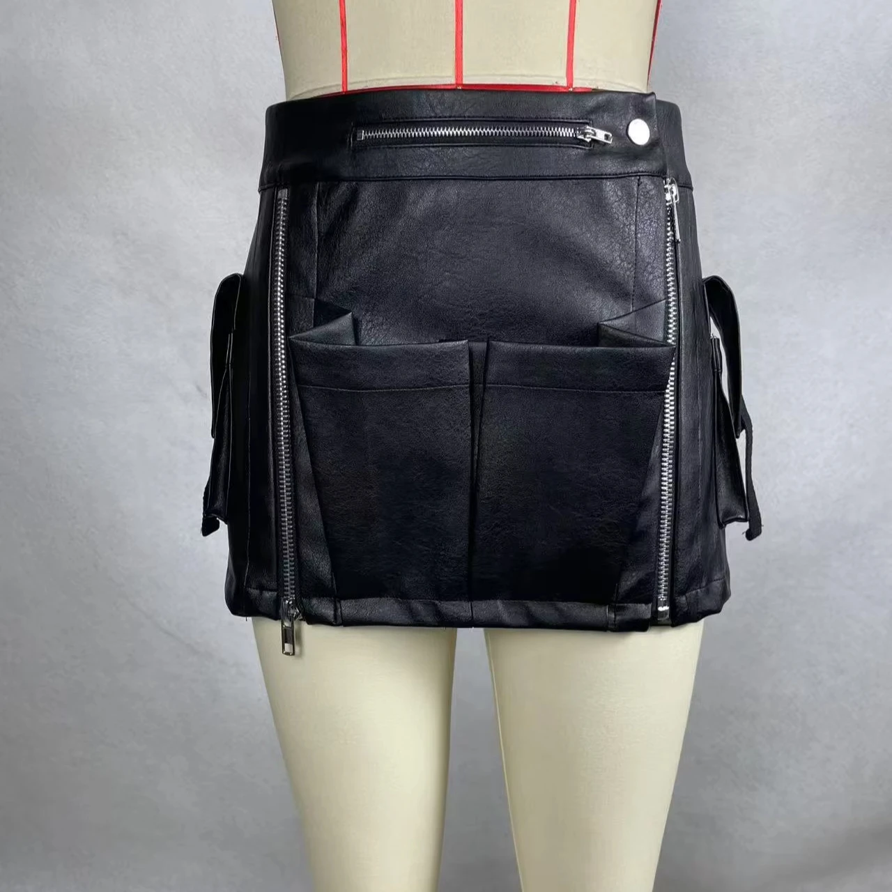 A Trendy, Cool, Short Leather Skirt With Multiple Compartments And Zippers.