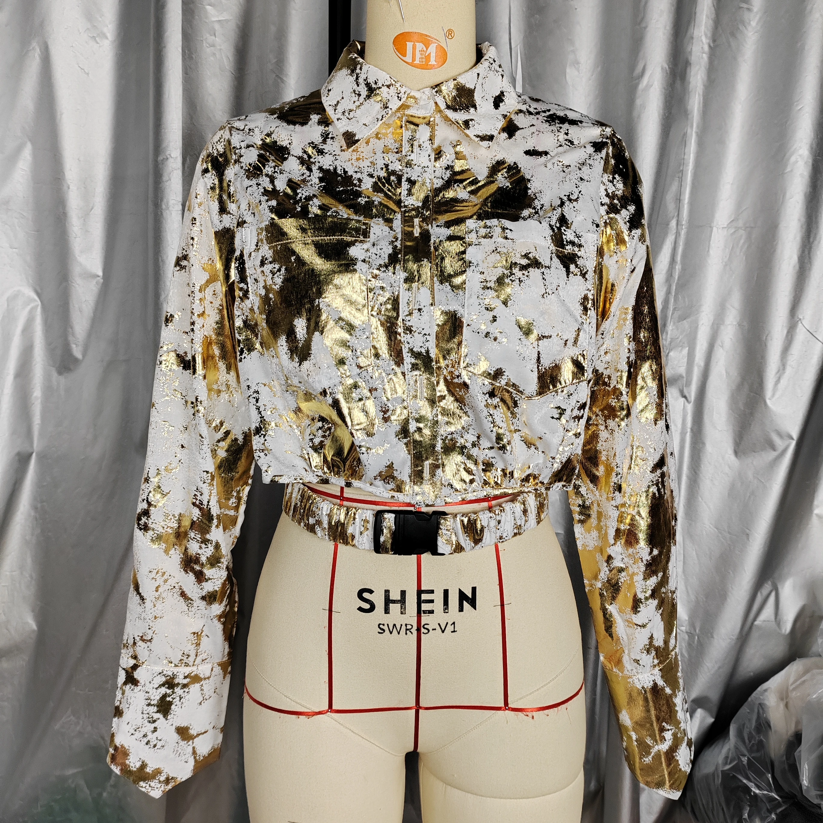 A Fashionable Shirt For Women With Gold Curly Patterns.