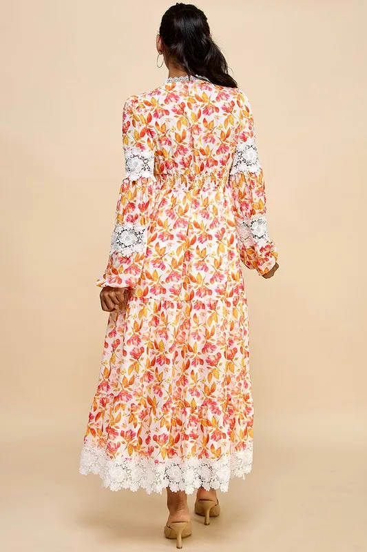 A Long Dress For Women Featuring Vibrant Floral Prints, Cutouts, And Lace Trim.