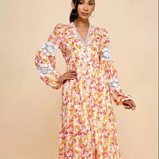 A Long Dress For Women Featuring Vibrant Floral Prints, Cutouts, And Lace Trim.